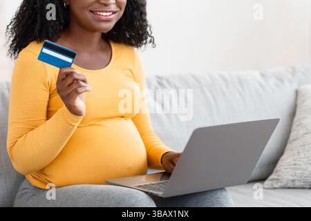 Mother shopping online with laptop and credit card Stock Photo