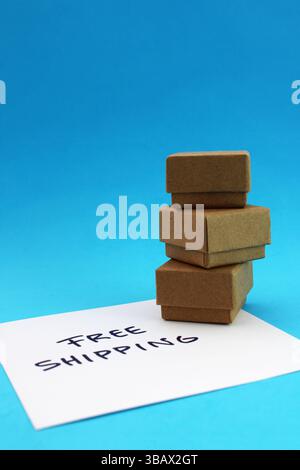 Free shipping phrase next to three delivered packages, cardboard boxes Stock Photo