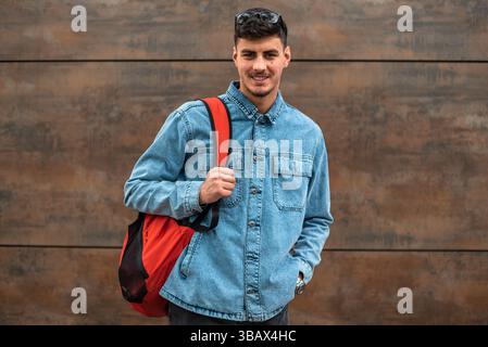 Portrait of a happy male college student isolated on background. Stock Photo