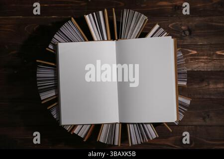 Open book on top of many half open ones, top view Stock Photo