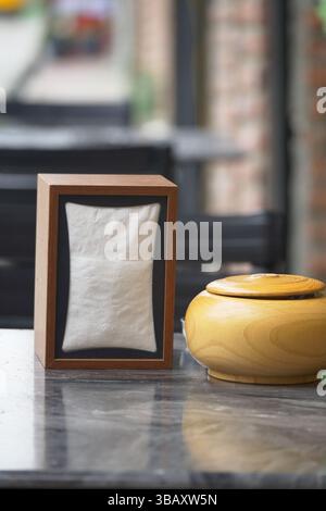 Decorative wooden box and container on a marble table outside Stock Photo