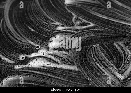 Abstract white soap curved lines on black background. Stock Photo