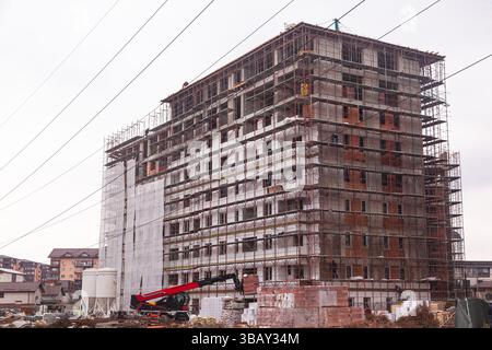 A construction site in the city where a new multi-story residential building is being built. Stock Photo