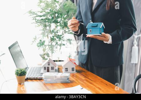 Real estate agents bid home in project to explain in detail to clients. Explain and present information about home and mortgage purchases. real estate Stock Photo