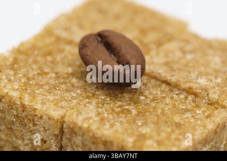 a beautiful picture, background with coffee beans and sugar, coffee grain lying on cubes of cane sugar Stock Photo