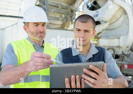 two engineers in hardhat is using a tablet computer Stock Photo