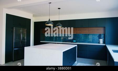 Interior Shot Of Stylish Modern Kitchen In Empty House Stock Photo