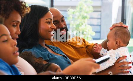 Multi-Generation African American Family With Baby Daughter Relaxing At Home On Sofa Together Stock Photo