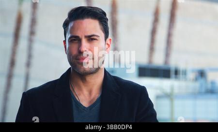 Portrait Of Thoughtful Mature Businessman Outside Office Building With City Skyline In Background Stock Photo