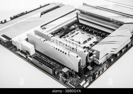 A close-up image of a high-performance motherboard showing two installed RAM modules Stock Photo