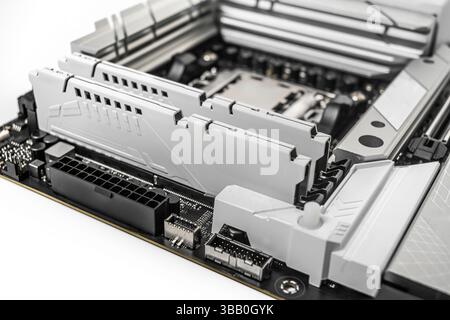 A close-up image of a high-performance motherboard showing two installed RAM modules Stock Photo