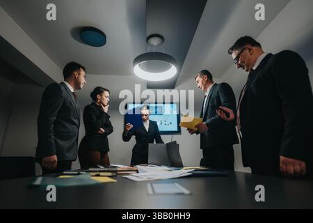 Professional meeting of executives analyzing data and discussing business outcomes in office Stock Photo