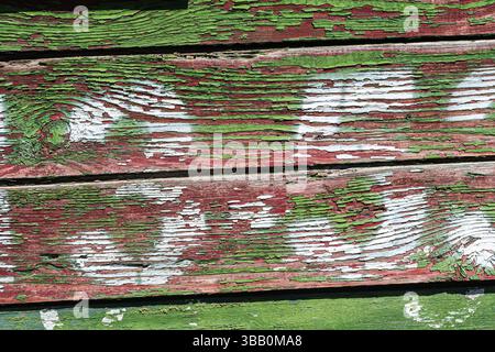 A background with the texture of wooden planks with peeling green paint and white numbers. Close-up, a wooden railway car from the Second World War wi Stock Photo