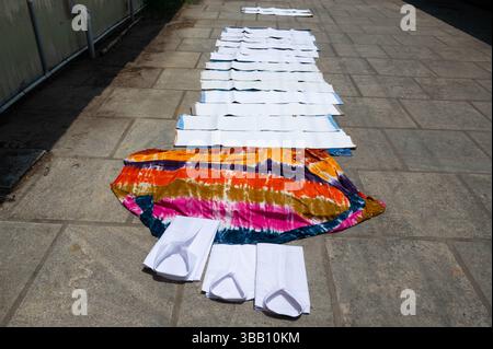 Clothes lying on the sidewalk for to dry, lifestyle and culture of  India, dhobi ghat laundry washing in Kochi, Asia Stock Photo