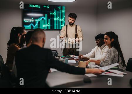 Team Collaborating During a Business Strategy Meeting with Data Visualization Stock Photo