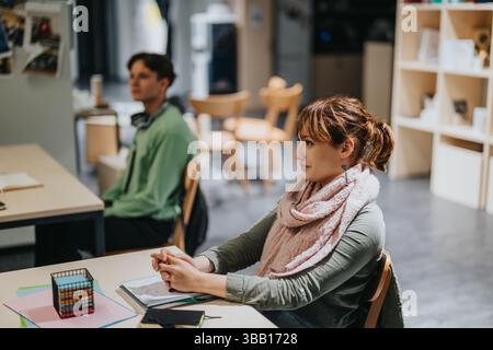 Engaged students in classroom with attentive elderly professor Stock Photo