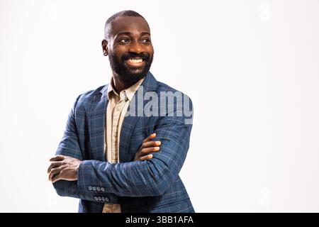 Portrait of happy and successful businessman. Black man in business suit is standing with arms crossed and smiling. Stock Photo
