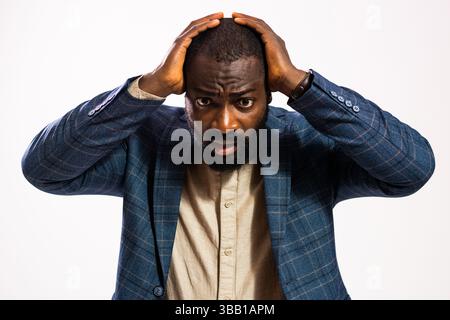 Portrait of tired and exhausted businessman. Black man in business suit is overworked and he is frustrated. Stock Photo