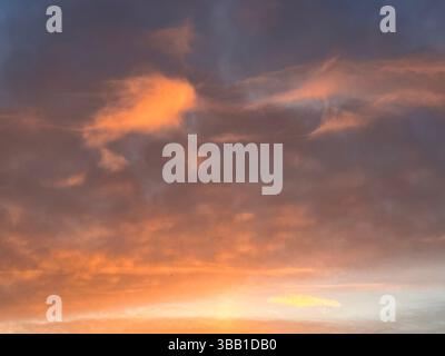 The sky is painted with beautiful sunset colors of orange, pink, and purple. Stock Photo