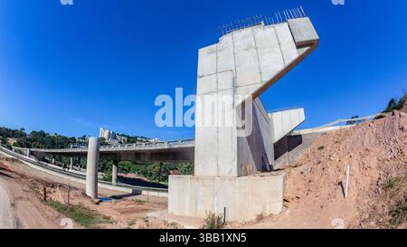 Construction new road highway fly-over bridge  ramp concrete molds close-up photo halfway progress expansion building projects. Stock Photo