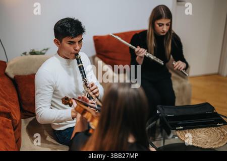 Young musicians practicing together at home with diverse musical instruments Stock Photo