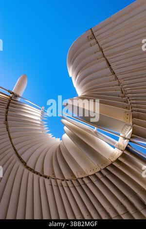 A white spiral, metal cover for a roof. Conceptual, abstract, background, infinity symbol, wave Stock Photo
