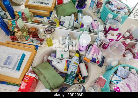 Miami Beach Florida,bathroom counter messy cluttered sink,overflowing toiletries,personal hygiene products,health and beauty items,perfume bottles,ski Stock Photo