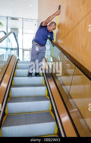Miami Florida,Brickell Financial District,Brickell Avenue,Hotel AKA Brickell Arch,inside interior lobby atrium,worker cleaning escalator railing,janit Stock Photo