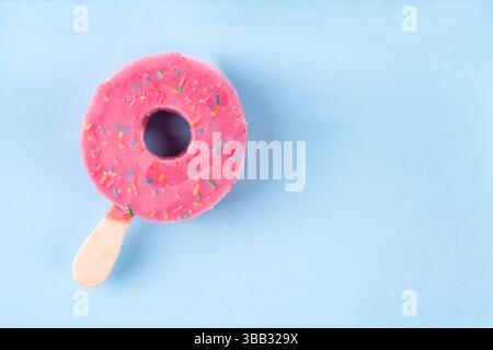 Summer vacation and holidays concept with ice cream in the form of pink donut lifebuoy, with the inscription I love summer. On a light blue background Stock Photo
