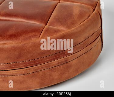 Round leather cushion showing detailed stitching and texture Stock Photo
