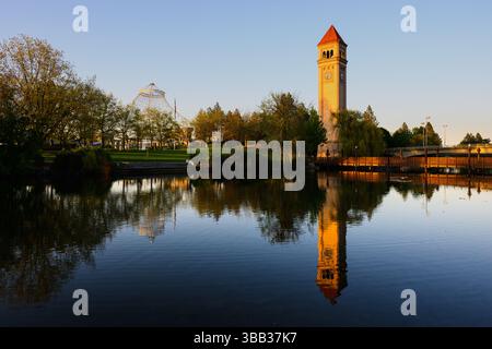 Spokane, WA, USA - May 1, 2025; Great Northern Clocktower reflecting in evening water of Spokane River Stock Photo