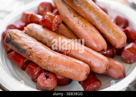 grilled sausages on a white plate, grilled close-up. Stock Photo