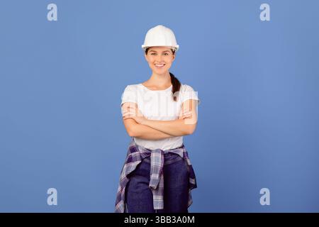 Confident young couple in hard hats ready for house repairment and renovation Stock Photo