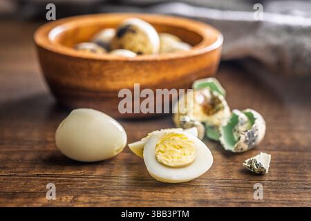 Boiled quail eggs on a wooden table. Stock Photo