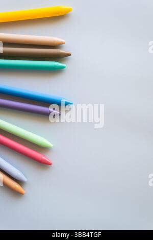 Creative school arrangement with school bus notebooks orange pen cup and colorful supplies on yellow background symbolizing childhood education back Stock Photo