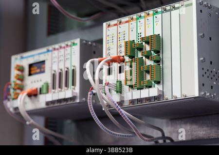 Modular PLC equipment in a control cabinet. Industrial automatic control system. Selective focus. Stock Photo