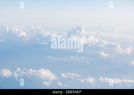 Vast expanse of soft clouds drifts across a pale blue sky. Fluffy clouds scattered across a light backdrop. Breathtaking panorama of clouds Stock Photo