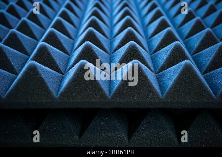 Detailed view of pyramid-shaped acoustic foam used for soundproofing in studios, music rooms or home theaters. Stock Photo