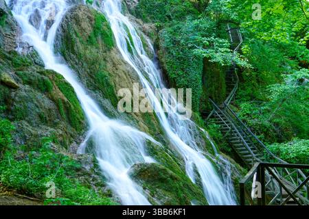 Mountain waterfall among moss-covered rocks. Stock Photo