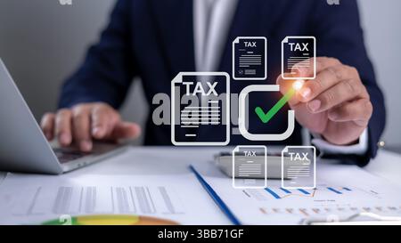 Tax documents and savings, Corporate and individual tax payment concept, Businessman using computer filling out corporate and personal income tax retu Stock Photo