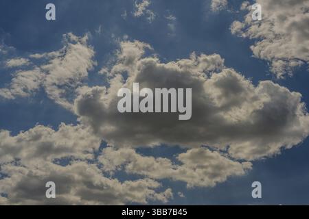 Large white clouds float in the blue sky on a sunny day, Bogen, Lower Bavaria Stock Photo