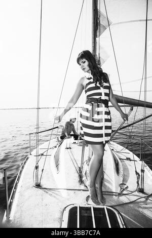 Young beautiful woman posing on the yacht in sunlight day Stock Photo