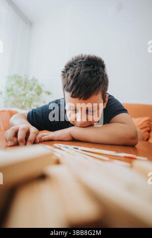 Grandmother and grandson enjoying a pick up sticks game at home Stock Photo