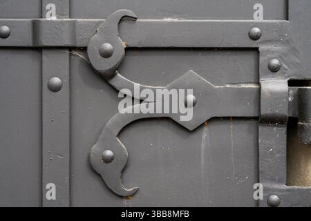 An antique metal bolt on the door is gray. High quality photo. Close-up. Stock Photo