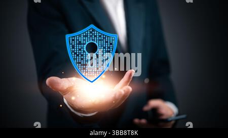 Cybersecurity concept with a business professional holding a virtual security shield. Ideal for illustrating data protection, encryption, and online s Stock Photo