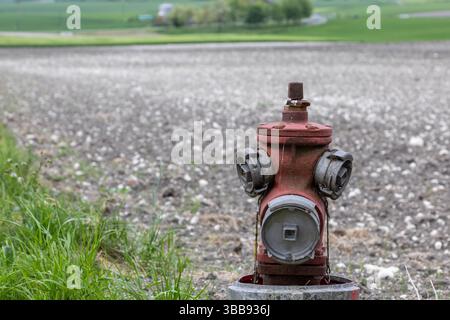red fire water pump on the side of the road Stock Photo