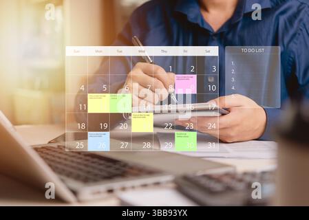 businessman planning his tasks using a calendar and to-do list on a smartphone. Efficient time management, work planning, and productivity concept. Stock Photo