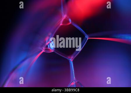 Purple and red liquid on dark background, perfect liquid shapes, glossy reflection Stock Photo