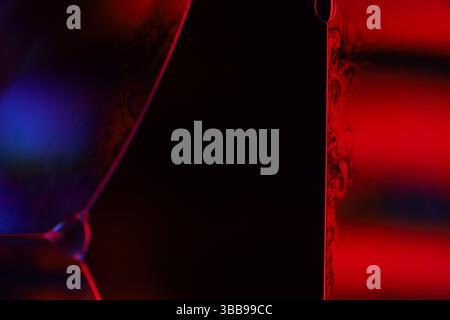 Purple and red liquid on dark background, perfect liquid shapes, glossy reflection Stock Photo