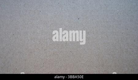 Carton paper background. Cardboard grey texture. Beige package paper surface. Stock Photo